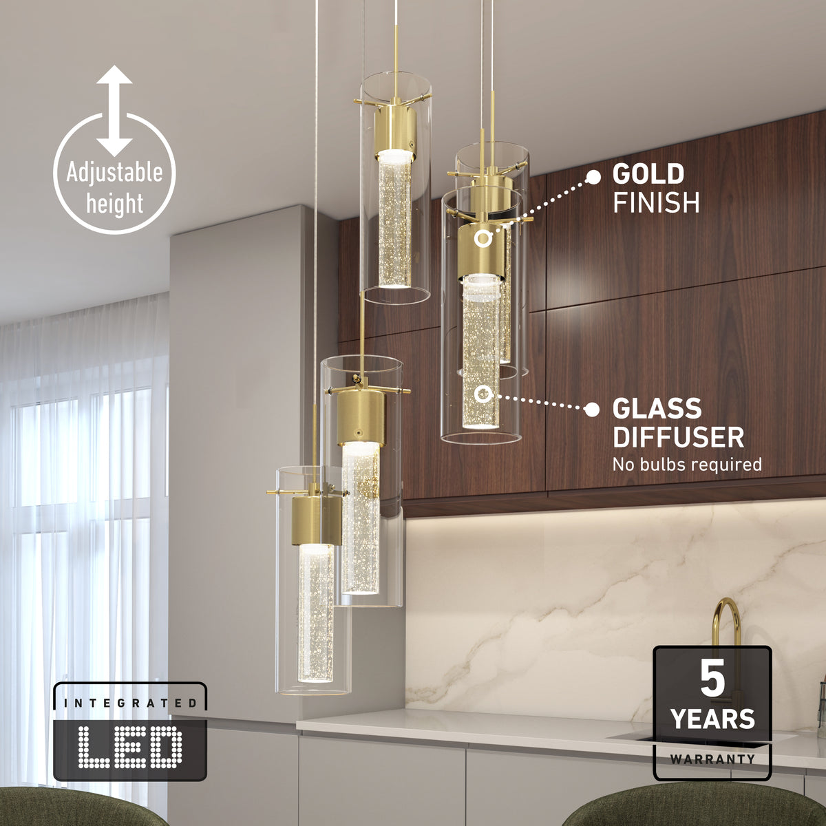 Four modern pendant lights with gold finish and glass diffusers hang above a kitchen counter. Labels highlight adjustable height, integrated LED, gold finish, glass diffuser, and a 5-year warranty. Marble backsplash and wood cabinets in background.