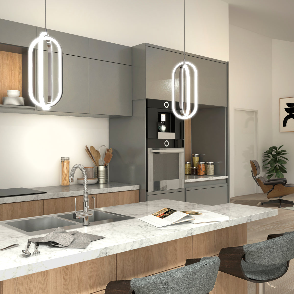 A modern kitchen with gray and wood cabinets, marble countertop, built-in appliances, two pendant lights, a sink, and bar stools. There are jars and utensils on the counter, and a stylish lounge chair in the background.