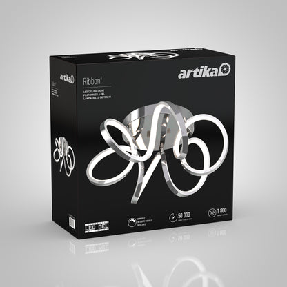 A black box displays the Artika Swirl Ribbon flush mount light, featuring a modern chrome and LED looping design. The packaging highlights key features: 50,000-hour lifespan and brightness of 1,800 lumens.