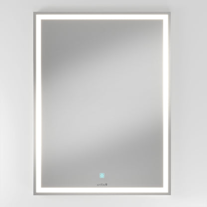The Artika Emeraude dimmable LED mirror 3 CCT is a rectangular, wall-mounted mirror with an illuminated LED border and a circular touch button at the bottom center, shown against a plain white background.
