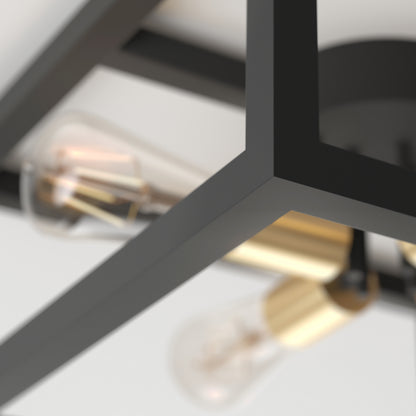 Close-up of the Artika Princeton 4-light flush mount light, featuring a modern black metal frame with brass accents and exposed bulbs, seen from below against a white ceiling.