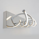 A modern wall-mounted LED light fixture with chrome finish and looped, curved design, emitting a soft white glow against a light gray wall.