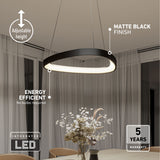 A modern black oval LED pendant light hangs above a dining table with a vase of flowers. Text highlights its adjustable height, matte black finish, energy efficiency, integrated LED, and 5-year warranty.