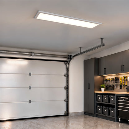 An Artika Sunray 48 in. x 12 in. ultra-thin LED ceiling light panel installed in a garage.