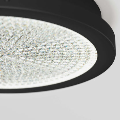 Close-up of Artika’s Glitter 14 in. LED Flush Mount Ceiling Light with a crystal-textured surface and black frame against a light background.