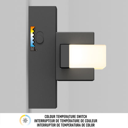 The Artika Ophelia modern LED bathroom vanity light features a sleek rectangular design and a 5 CCT color temperature switch with a multicolored scale. Text below the switch explains its use in three languages. Emits soft white illumination.