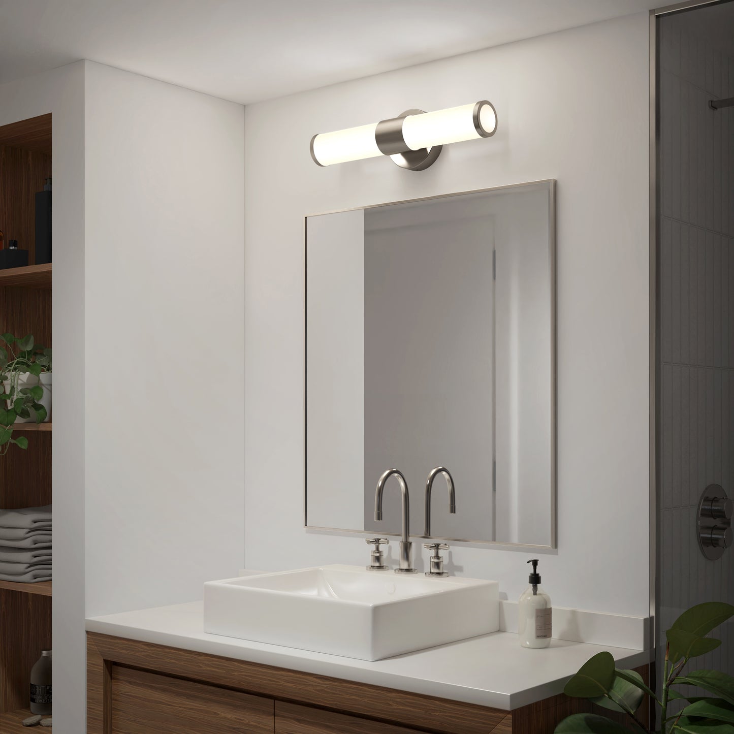 A modern bathroom features a square white sink, double faucets, large rectangular mirror, Artikas Adina modern bathroom vanity light 3 CCT overhead, wooden vanity, towel shelves, and a plant in the corner.