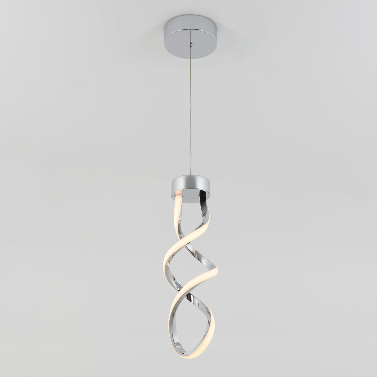 A modern pendant light with a twisted, ribbon-like LED design hangs from a ceiling mount on a thin wire against a plain white background.