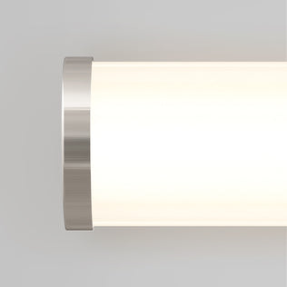 A close-up of the Artika Adina modern bathroom vanity light 3 CCT, softly glowing against a light gray background.