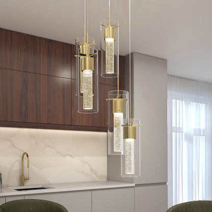 Modern kitchen featuring dark wood and light gray cabinets with a marble backsplash. The Artika Essence 5-light LED pendant, with gold and glass bubble detail, hangs above the countertop. Large windows fill the space with natural light.