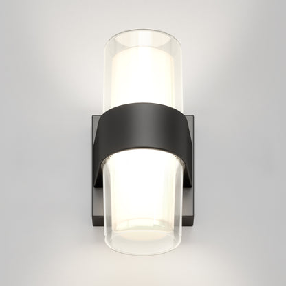 The Artika Colton modern LED indoor-outdoor wall light 5 CCT features a black rectangular base and two cylindrical frosted glass shades, casting soft white light up and down on any neutral wall.