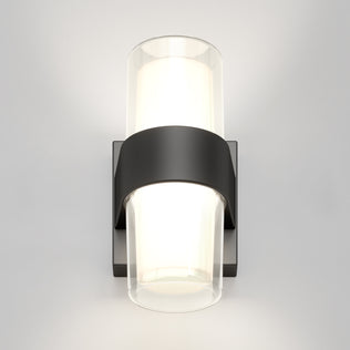 The Artika Colton modern LED indoor-outdoor wall light 5 CCT features a black rectangular base and two cylindrical frosted glass shades, providing up-and-down lighting in a sleek, contemporary wall-mounted design.