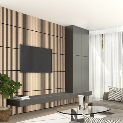 A modern living room features a TV on the Artika-CAN-dev Sonolok 15.5 ft sound-absorbing wall panel kit, floating cabinets, a round glass coffee table, gray sofa, potted plant, and sheer white curtains letting sunlight in.