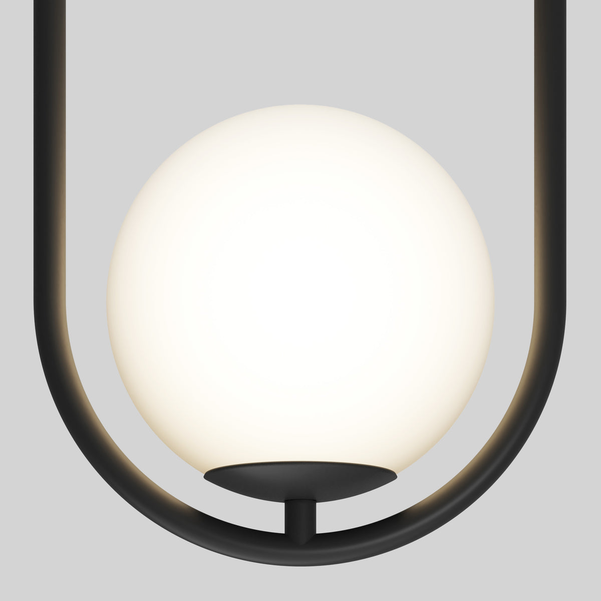 A modern pendant light with a white frosted glass globe held by a black metal frame in a U-shape, set against a plain light gray background.