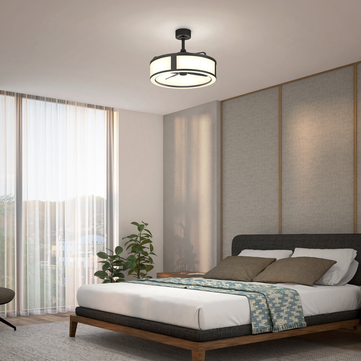 A modern bedroom with a large bed, cushioned headboard, patterned blanket, decorative pillows, plant, large window with sheer curtains, and a contemporary ceiling light fixture.