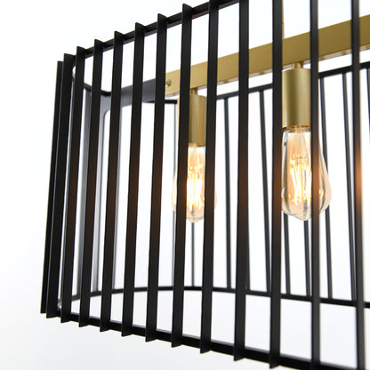 A close-up of the Artika Gatsby pendant light shows exposed Edison bulbs in a rectangular black metal cage with brass accents, set against a plain white background.