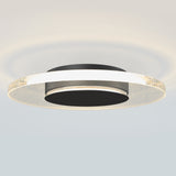 A modern, circular ceiling light fixture with a black center and a glowing, translucent outer ring featuring tiny embedded bubbles, casting soft illumination on the ceiling.
