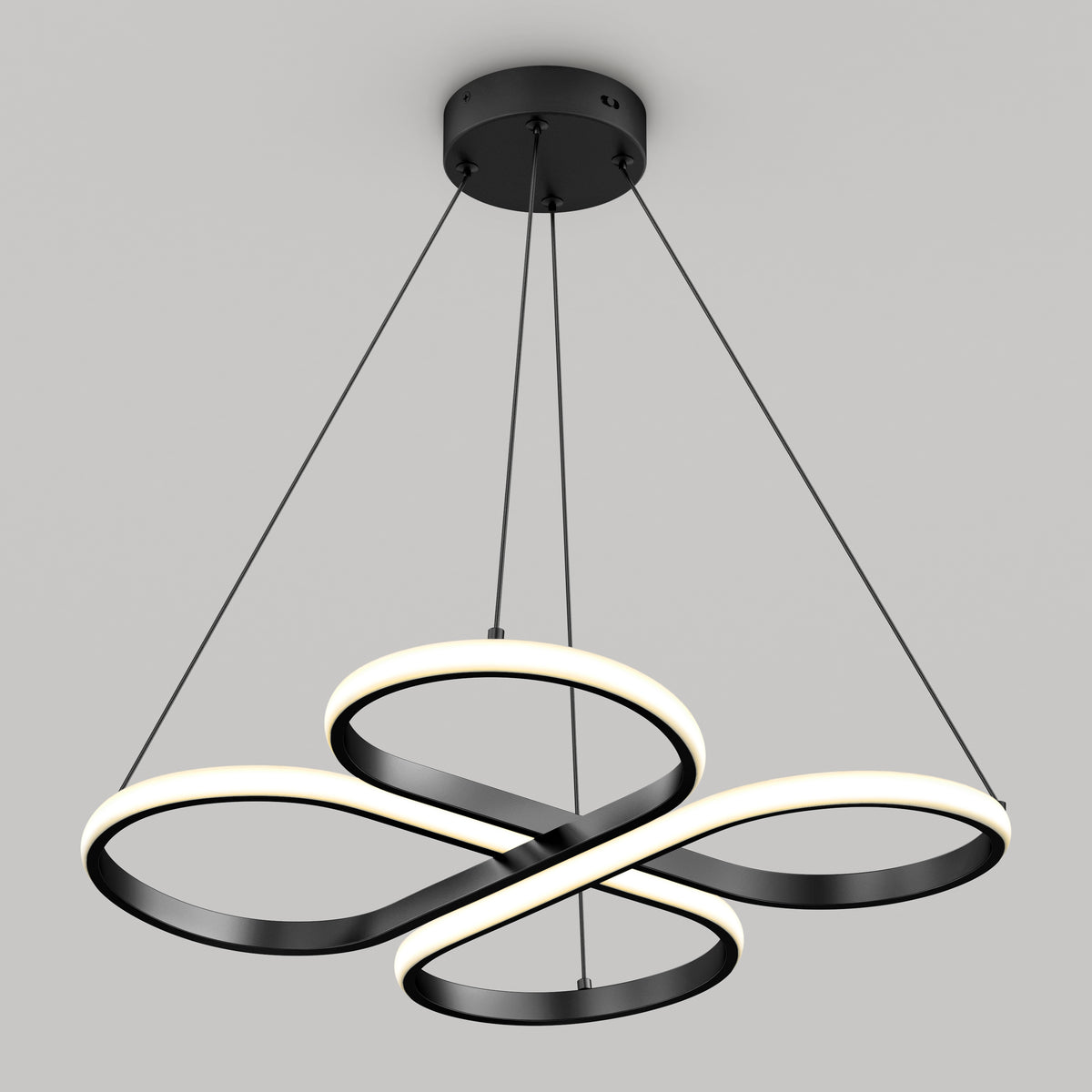 A modern, black and white ceiling light fixture with three interlocking, illuminated rings suspended by four cables from a round black ceiling mount, against a plain gray background.