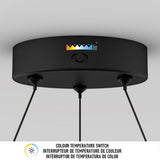A close-up of a black ceiling-mounted device with three hanging wires and a color temperature switch showing five settings, ranging from warm yellow to cool blue. Below is text in English and French about the color temperature switch.
