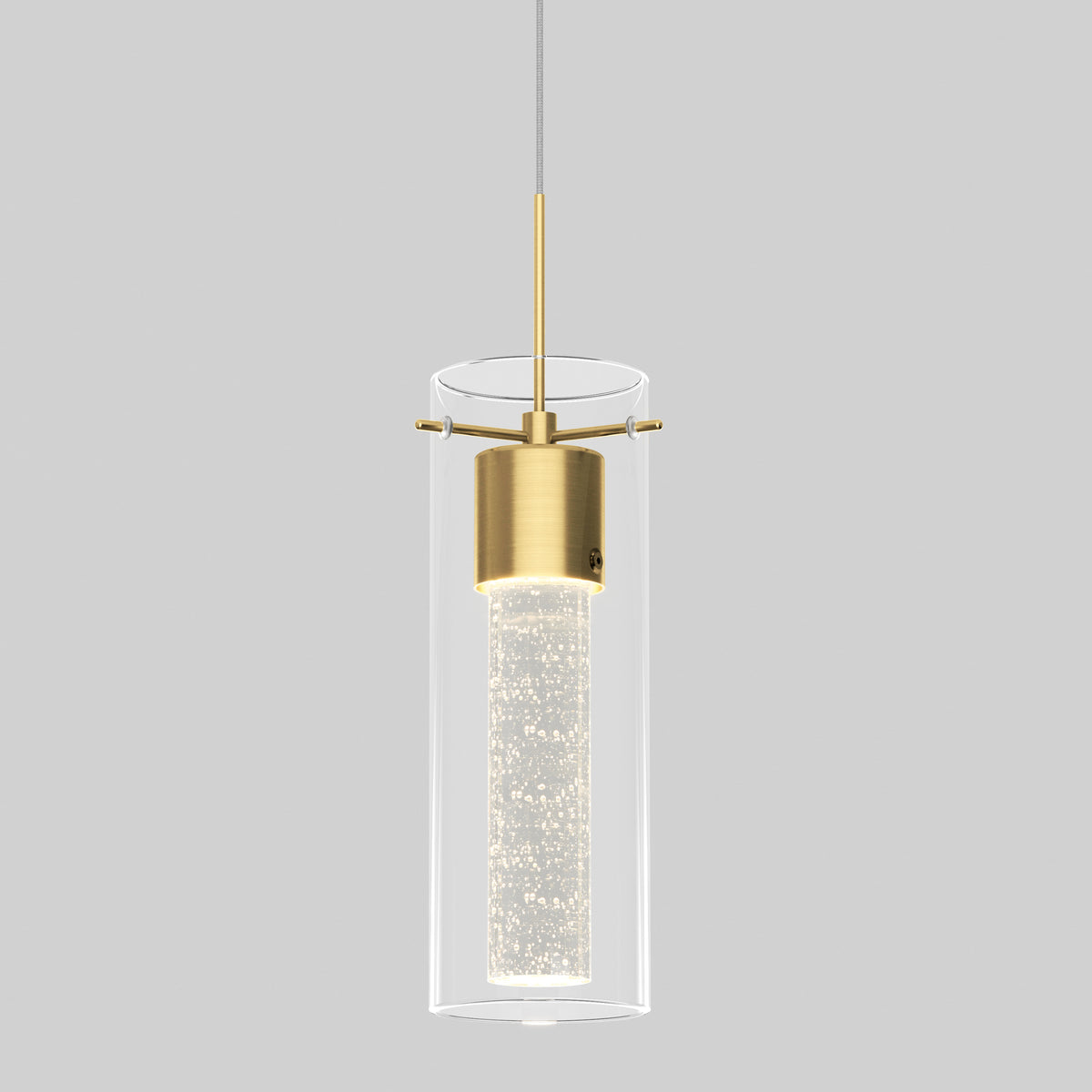 A modern pendant light with a cylindrical glass shade, brass accents, and an inner tube that appears to contain small sparkling bubbles, hanging from a thin cord against a plain gray background.