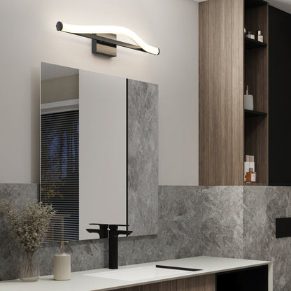 Modern bathroom featuring the Artika Arc modern LED bathroom vanity light (5 CCT) above a large mirror, with a sleek black faucet, decorative vase with dried flowers, gray and wood-textured walls, and built-in shelves for toiletries.