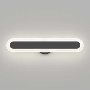 The Artika Pista modern LED bathroom vanity light 5 CCT is an oval, dimmable fixture featuring a black center and glowing white border, shown mounted on a light gray wall.