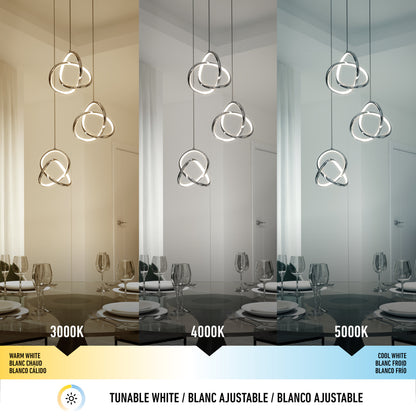 The Artika Zephyr 3-light LED pendant is featured in a dining room, displaying warm, neutral, and cool tunable white light. This dimmable chandelier combines versatility and modern style for customizable lighting design.