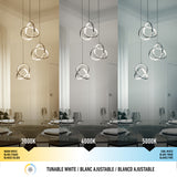 Three pendant lights hang over a dining table set with plates and glasses, shown under three different white light temperatures: 3000K (warm), 4000K (neutral), and 5000K (cool), with labels and a color scale below.