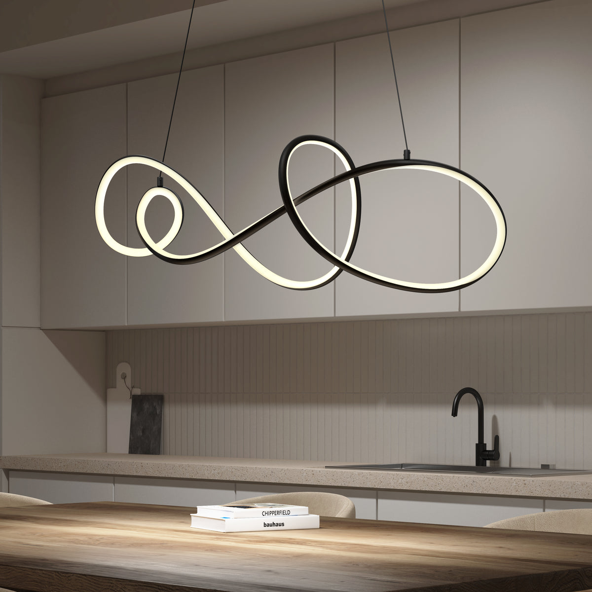 A modern kitchen with white cabinets, a black faucet, and a wood dining table features a unique, glowing infinity-shaped pendant light hanging above the table.