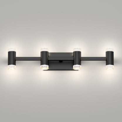 The Artika Mist modern LED bathroom vanity light features six horizontally arranged cylindrical lights in black, wall-mounted, casting a soft glow against a light gray wall. Offers 5 CCT settings for customizable lighting.