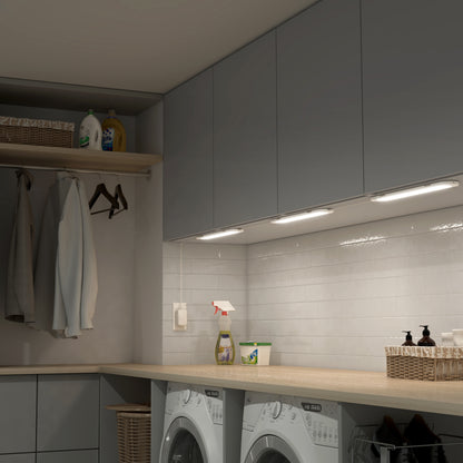 Modern laundry room with gray cabinets, washing machines, and Artika’s Impulse Under-Cabinet LED Light RGB+CCT with remote.