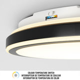 Close-up of a modern ceiling light with a color temperature switch, featuring a small adjustment lever and a colored indicator. Text below describes the switch in English, French, and Spanish.