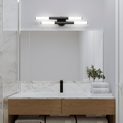 Modern bathroom with a large mirror, wooden vanity, black faucet, stacked white towels, green plant in a vase, and marble accents. Two Artika Boro LED modern bathroom vanity lights (5 CCT) are mounted above the mirror.