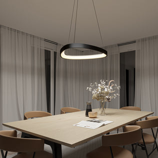 A modern dining room with a light wood table, tan chairs, white curtains, and a vase of dried flowers on the table. Overhead hangs the Artika Bjorn modern LED pendant light 5 CCT, adding stylish illumination.