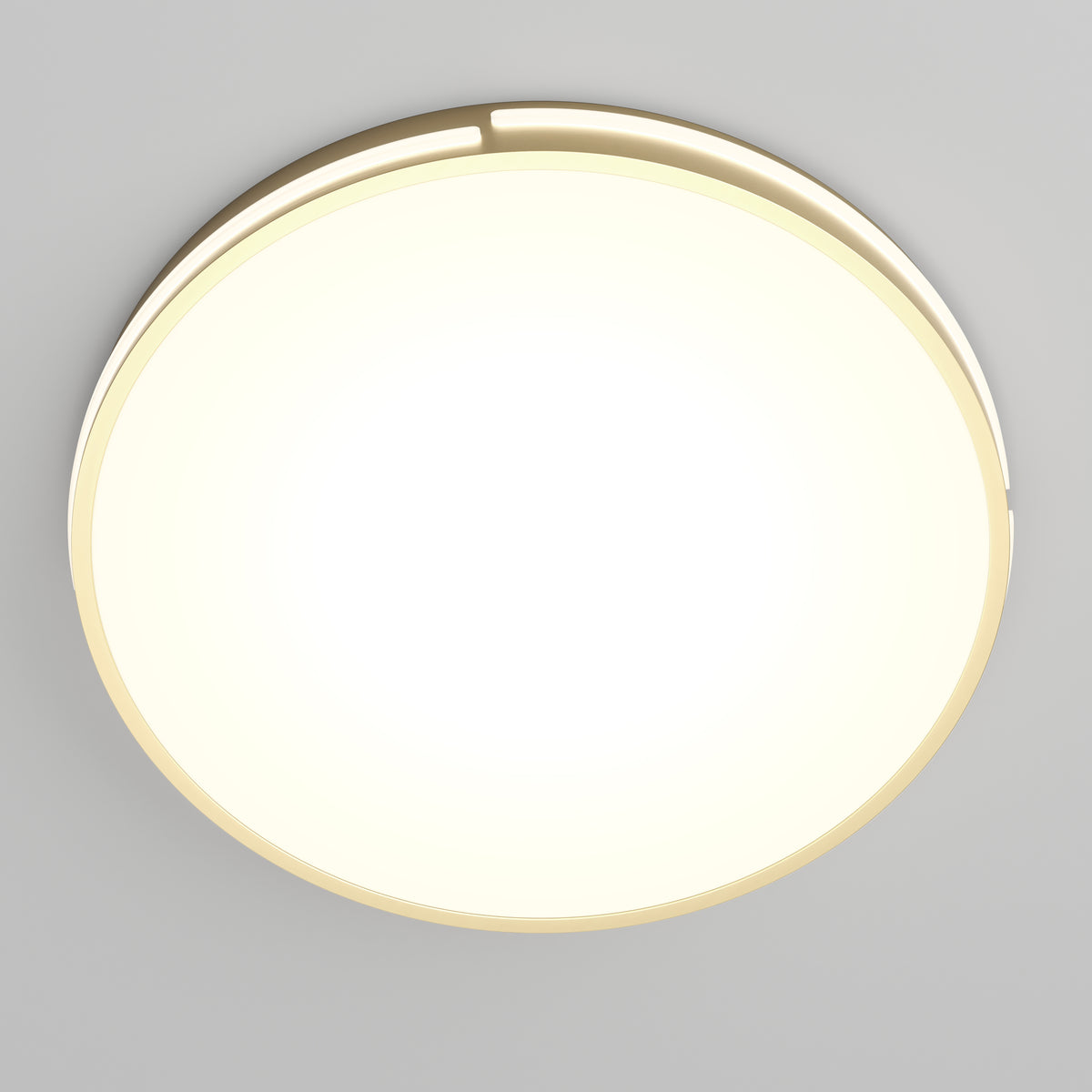 A round, modern ceiling light fixture with a glowing white center and a thin gold outer rim, mounted on a smooth, light gray ceiling.