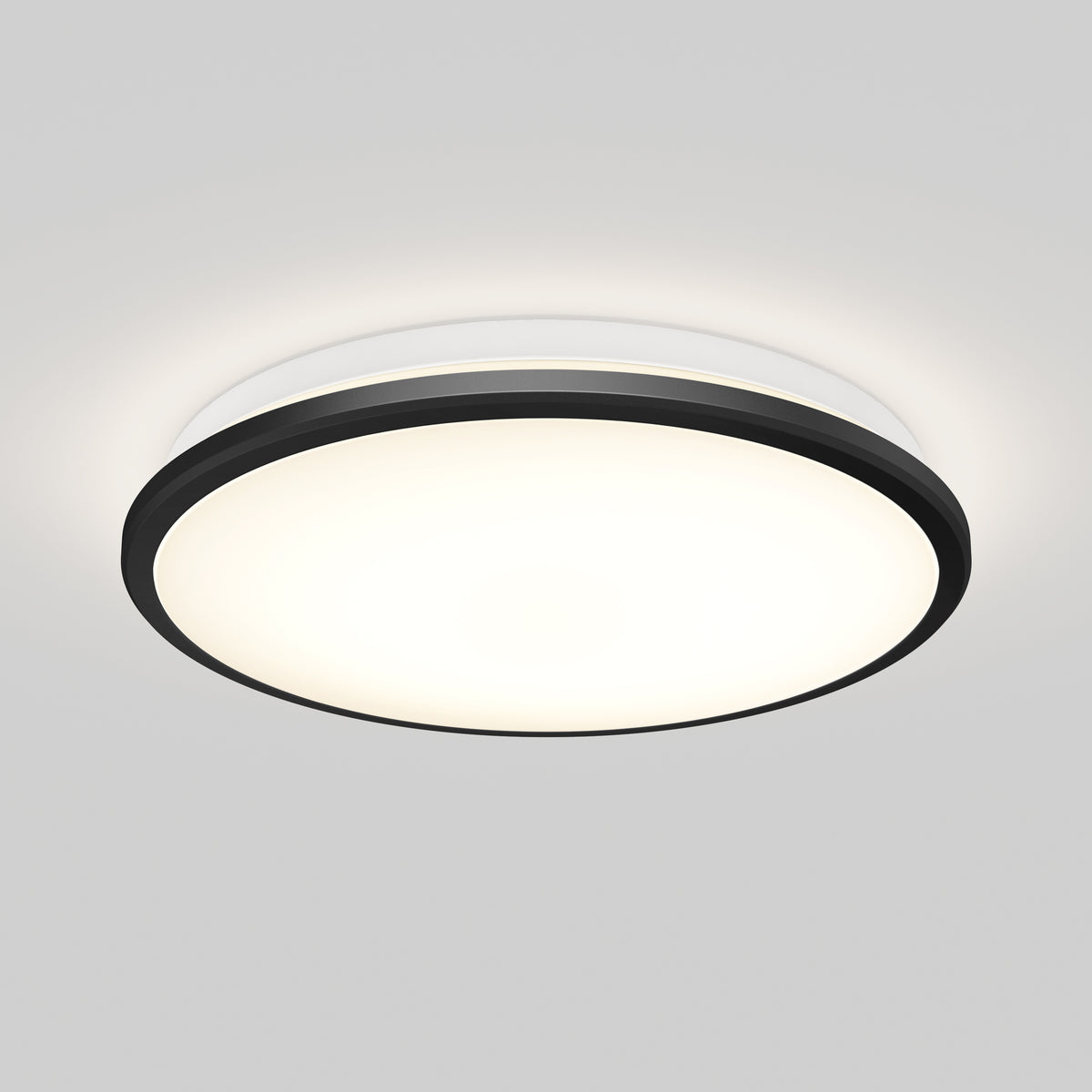 A round, modern ceiling light fixture with a black outer rim and a white frosted center, mounted on a plain white ceiling and emitting a soft, even glow.