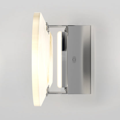The Artika Selena 3 CCT LED bathroom vanity light features a modern wall-mounted design with a rectangular metal base and a circular frosted glass shade, illuminated and shown from the side against a plain light gray background.