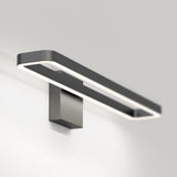 A modern, rectangular wall-mounted LED light fixture with a sleek, minimalist black and white design, attached to a plain light-colored wall.