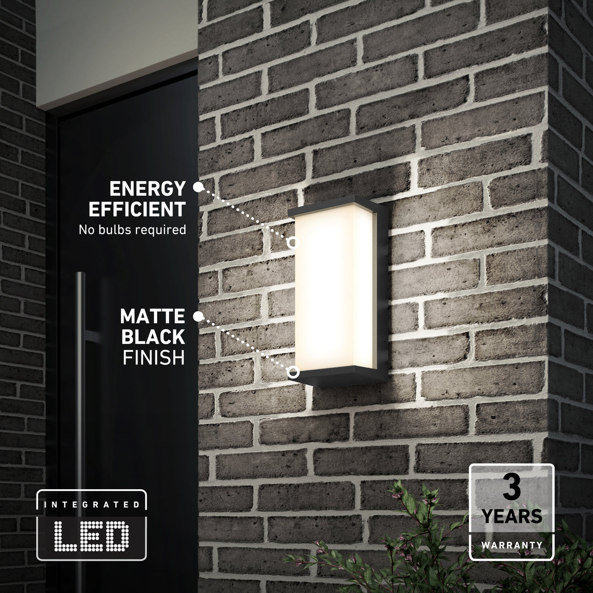 A modern rectangular LED wall light with a matte black finish is mounted on a brick exterior wall. Text highlights its energy efficiency, no bulbs required, and a 3-year warranty. Some greenery is visible below.