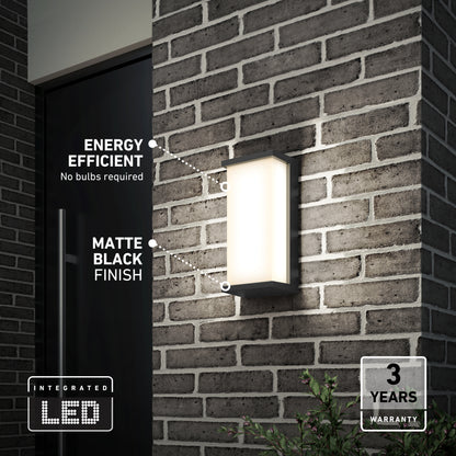 The Artika Faro modern LED indoor-outdoor wall light 3 CCT, with a matte black finish, is mounted on a brick wall. It features energy efficiency, integrated LED (no bulbs needed), and includes a 3-year warranty.