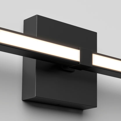 The Artika Convertible Pro 2 Wall Mounted bathroom vanity light features a sleek black rectangular base and slim horizontal LED bar, emitting a soft white glow, and is shown mounted on a plain white wall.