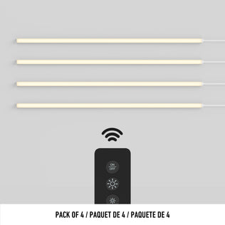 Four Lumilok LED Wall Panel Lights by Artika with black remote, shown on light background. Text: Pack of 4 / Paquete de 4.
