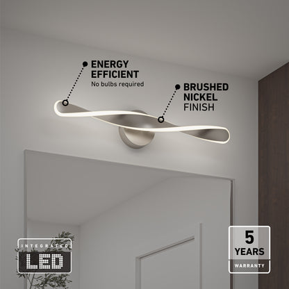 The Artika Finley LED modern bathroom vanity light 3 CCT, mounted above a mirror, features a twisting design, energy efficiency, brushed nickel finish, integrated LED, and includes a 5-year warranty.
