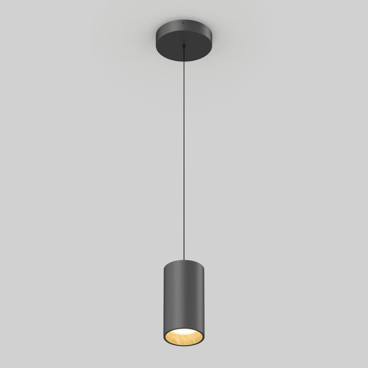 The Artika Alton mini LED pendant light 5 CCT features a sleek black cylindrical design, suspended by a slim cord, casting a warm glow against a light gray background.