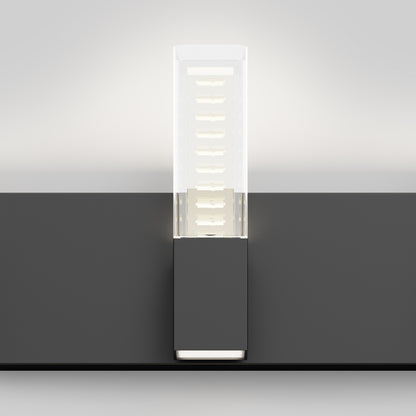 The Artika Hologram LED modern bathroom vanity light 5 CCT features a rectangular frosted glass shade, emits soft upward and outward light, and is mounted on a dark gray base against a neutral background.