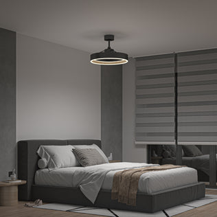 A modern bedroom features a gray upholstered bed, white bedding, brown throw, round bedside tables, a large window with layered gray blinds, and is lit by the Artika Alton 24 in. LED modern ceiling fan with remote. Décor uses neutral tones and minimalist style.