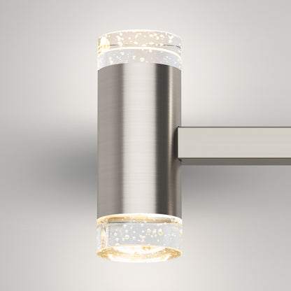The Artika Mist modern LED bathroom vanity light 5 CCT features a cylindrical brushed metal body with bubble-embedded transparent ends, casting a soft white glow on a light gray background.