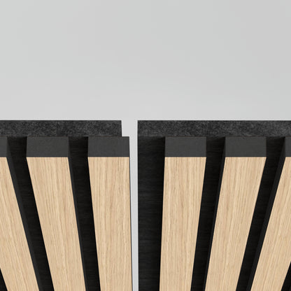 Close-up of two Artika Sonolok sound-absorbing wall panel kits with alternating light and dark wood slats, separated by a slim vertical gap, against a light gray background.