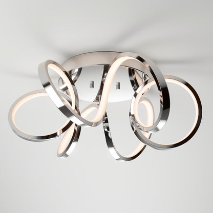 The Swirl Ribbon flush mount light by Artika features intertwined metallic loops with integrated LED lighting, mounted on a white ceiling for a sleek, artistic look.