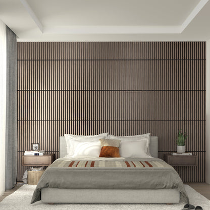 A modern bedroom features a large bed, neutral bedding, two nightstands, and an Artika-CAN-dev Sonolok 15.5 ft sound-absorbing wall panel kit as a textured accent wall. Natural light filters through sheer curtains onto a cozy rug.